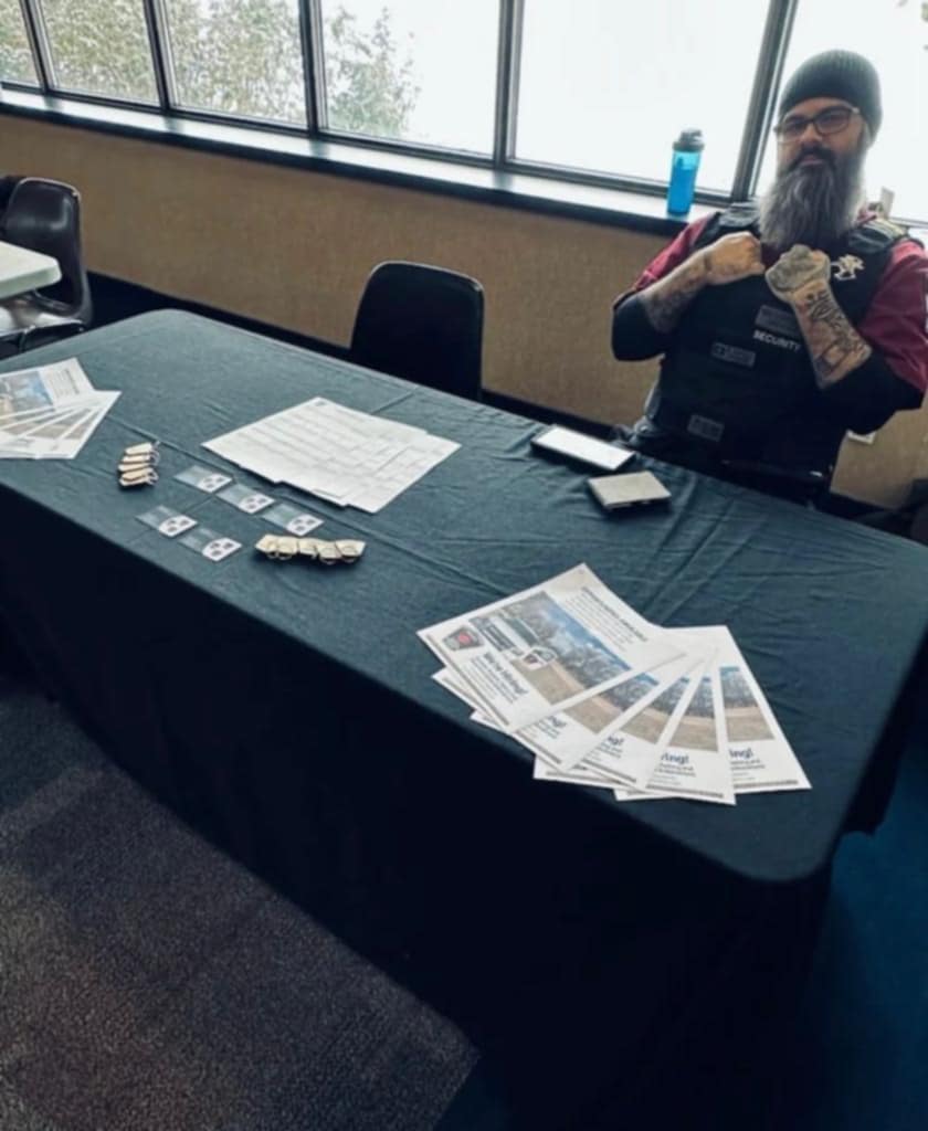 Security staff at a community information table