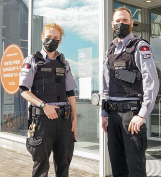 Licensed security guards on a static site post